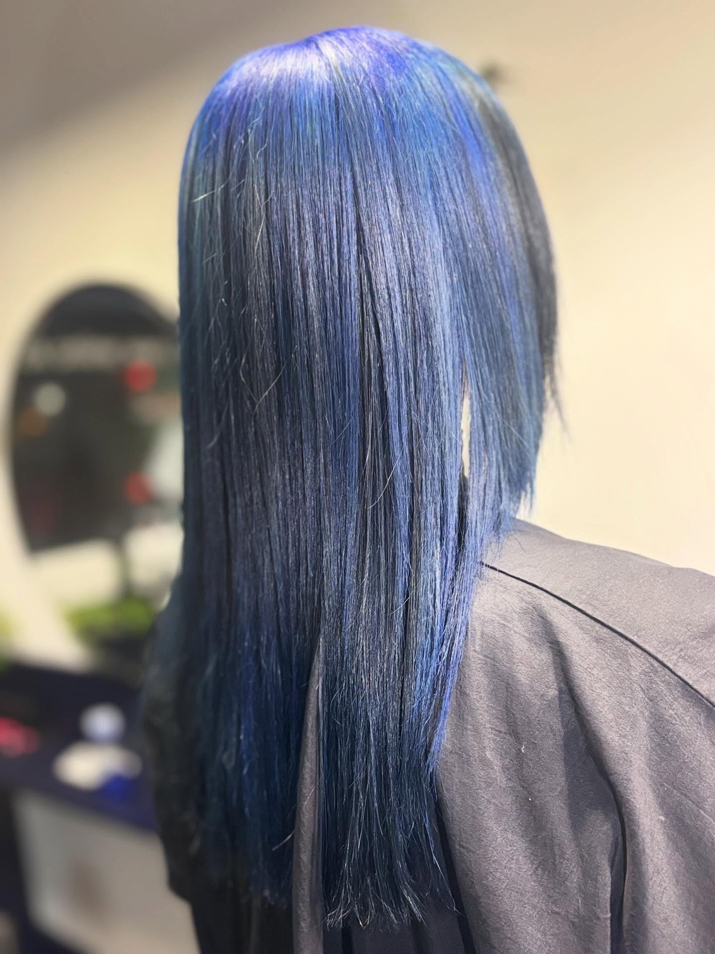 Sleek vivid blue hair colour with a glossy straight finish